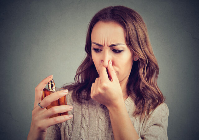 Young girl displeased with perfume